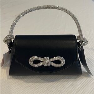 Black pocketbook/tote with knotted crystal handle and crystal bow detail.